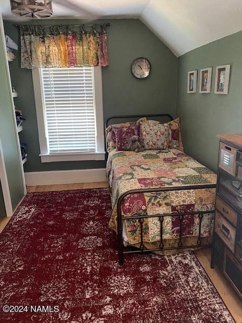 bedroom with lofted ceiling