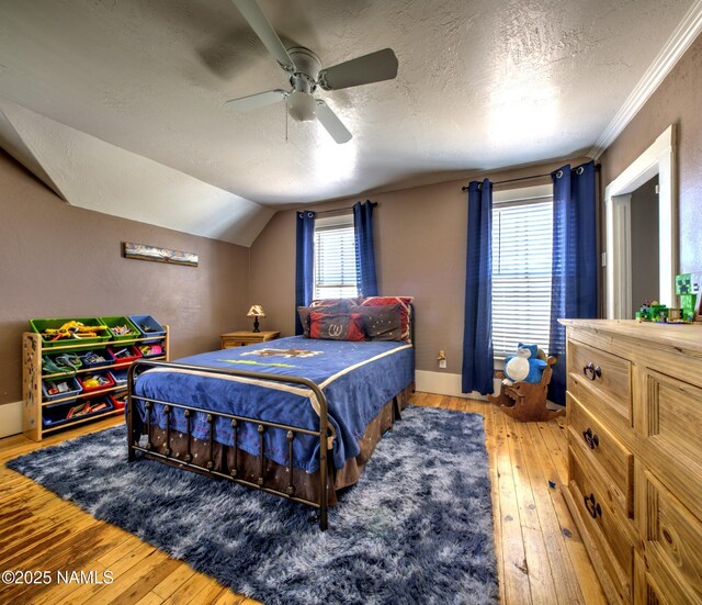 8134 Mclaws Ave, Joseph City, AZ 86032 - bedroom with hardwood / wood-style floors, a textured ceiling, ceiling fan, crown molding, and lofted ceiling