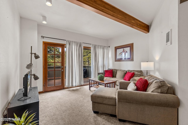 living room featuring beamed ceiling and carpet floors