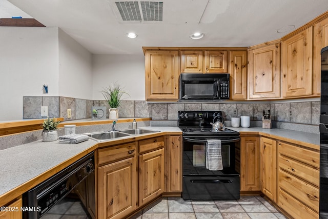 kitchen with tasteful backsplash, sink, and black appliances