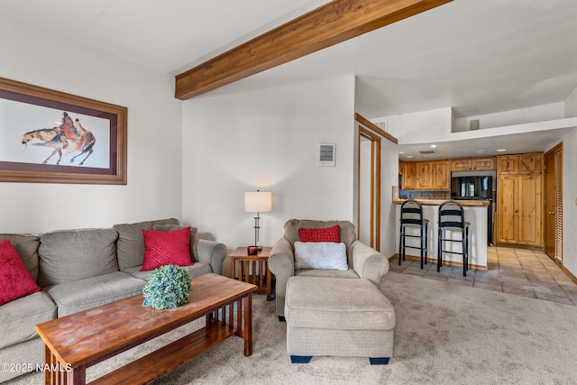 carpeted living room with beam ceiling