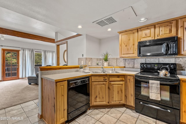 kitchen featuring sink, backsplash, black appliances, and light colored carpet