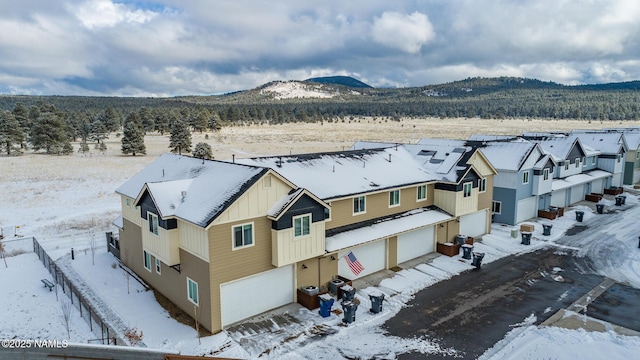 snowy aerial view featuring a mountain view