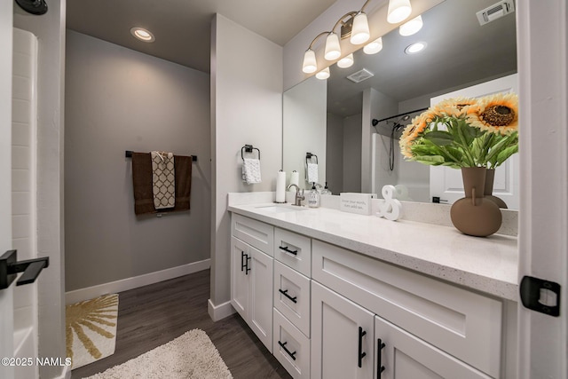 bathroom featuring vanity, hardwood / wood-style flooring, and walk in shower