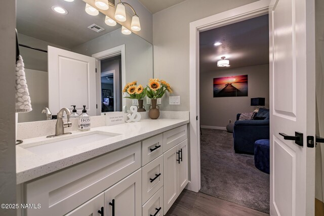 bathroom featuring vanity and wood-type flooring