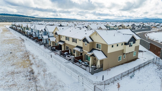 snowy aerial view with a mountain view