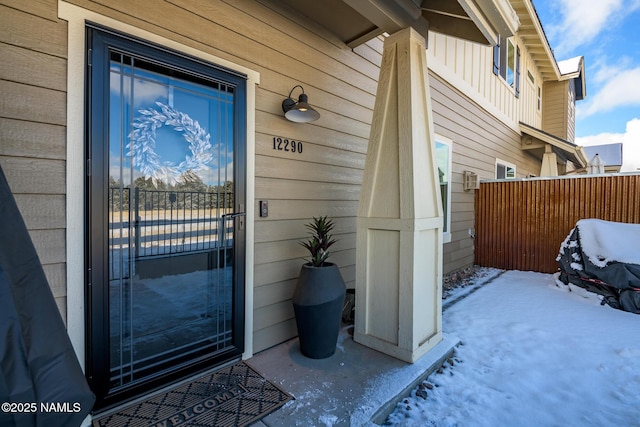 view of snow covered property entrance