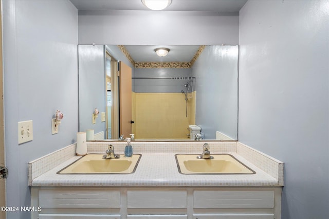 bathroom with vanity and a shower