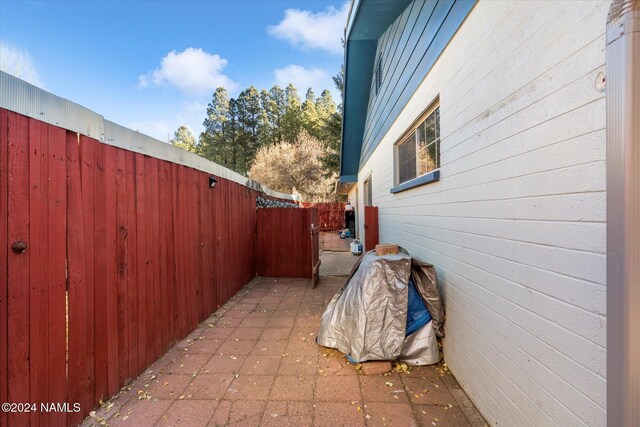 view of property exterior with a patio area