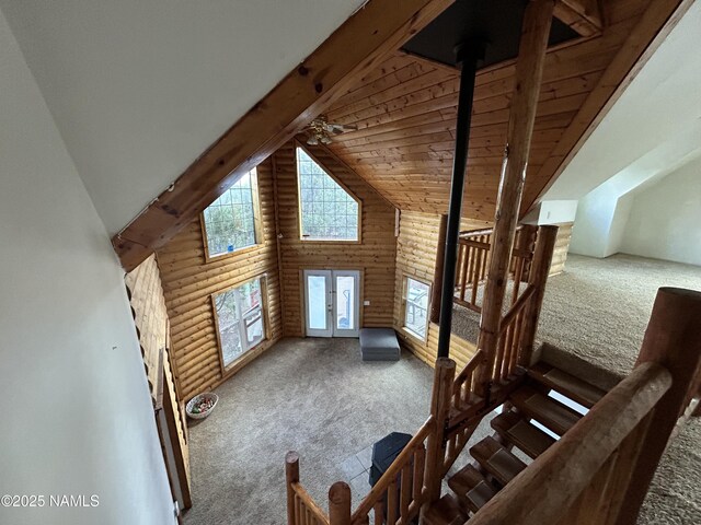 8120 N Cassity Trl, Williams, AZ 86046 - additional living space with carpet flooring, high vaulted ceiling, log walls, beam ceiling, and french doors