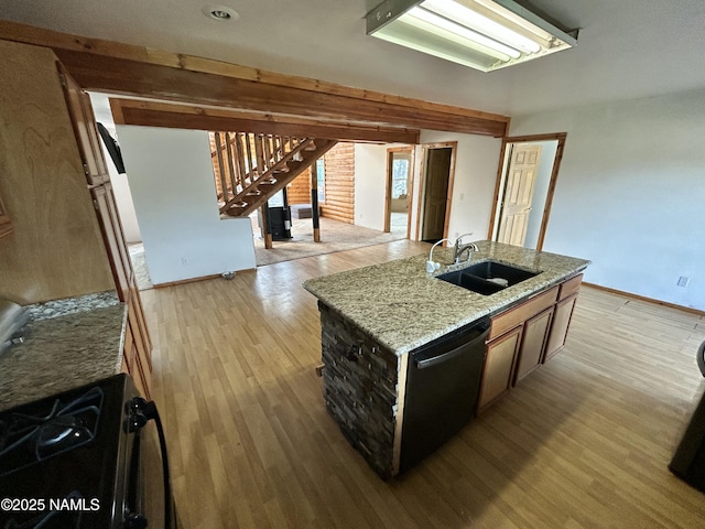 8120 N Cassity Trl, Williams, AZ 86046 - kitchen with a sink, baseboards, dishwasher, light wood-style flooring, and light stone counters