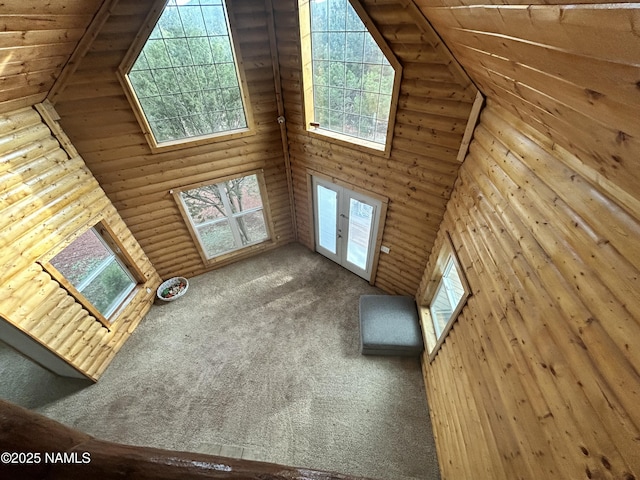 8120 N Cassity Trl, Williams, AZ 86046 - unfurnished living room featuring high vaulted ceiling, wood ceiling, log walls, and carpet flooring