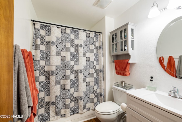 bathroom with toilet and vanity