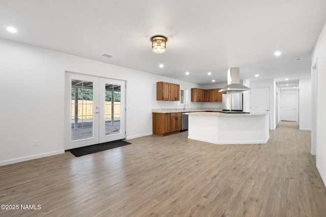 3540 N Walker St, Flagstaff, AZ 86004 - kitchen featuring brown cabinetry, island range hood, dishwasher, french doors, and visible vents