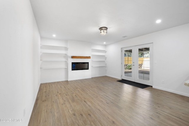 3540 N Walker St, Flagstaff, AZ 86004 - unfurnished living room featuring recessed lighting, wood finished floors, french doors, baseboards, and a glass covered fireplace