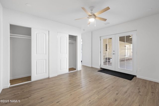 3540 N Walker St, Flagstaff, AZ 86004 - unfurnished bedroom with wood finished floors, two closets, french doors, baseboards, and visible vents