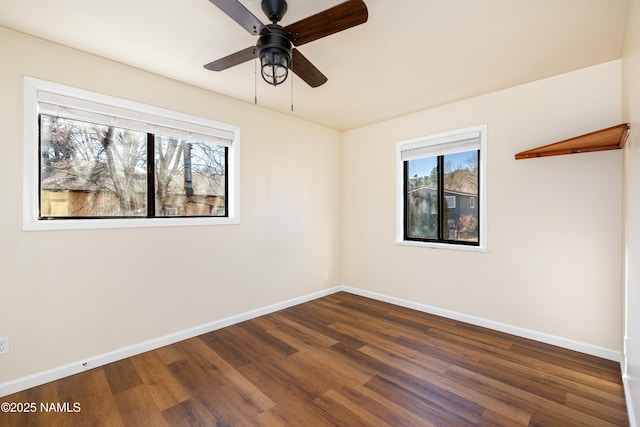 empty room with dark hardwood / wood-style floors and ceiling fan