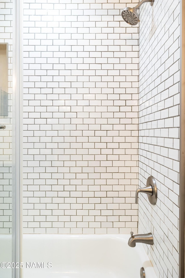 interior space featuring tiled shower / bath