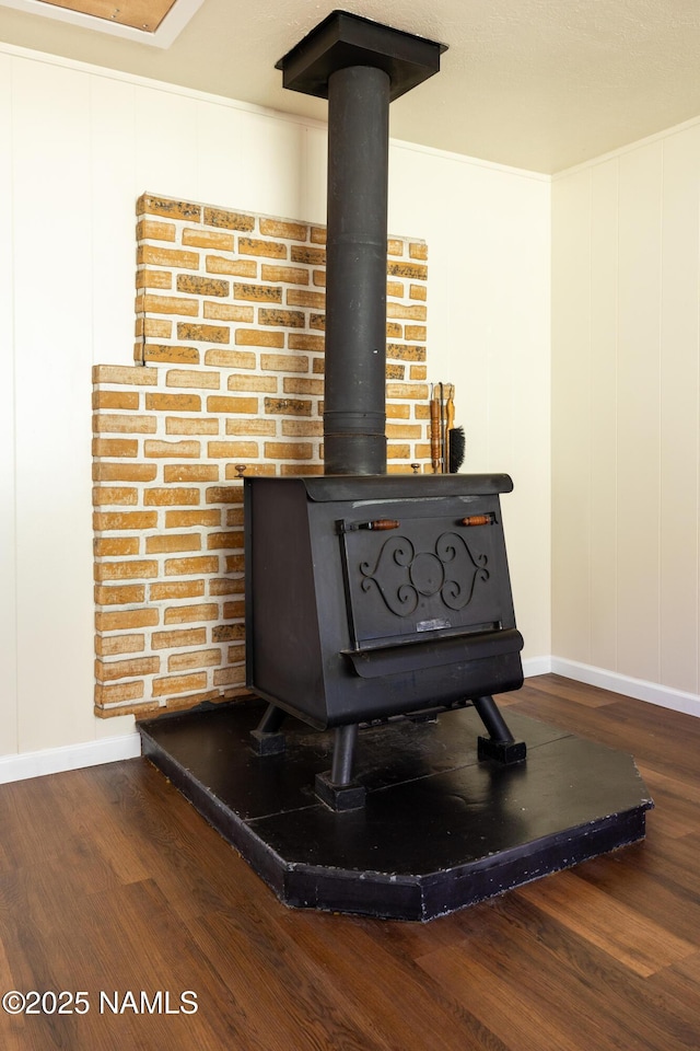 details featuring hardwood / wood-style floors and a wood stove