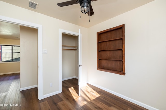 unfurnished bedroom with a closet, ceiling fan, and dark hardwood / wood-style flooring