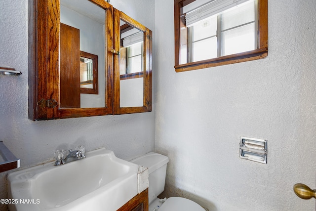 bathroom featuring sink and toilet