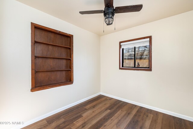 unfurnished room with ceiling fan and dark wood-type flooring