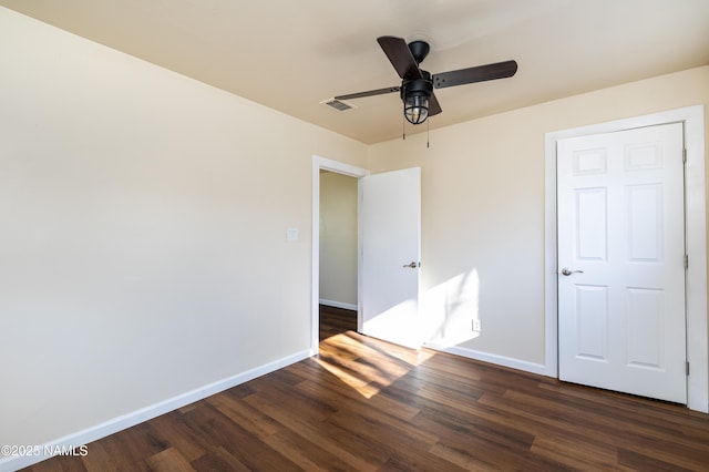 unfurnished bedroom with dark hardwood / wood-style floors and ceiling fan