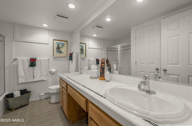 38 Cosnino Rd, Flagstaff, AZ 86004 - full bathroom featuring a baseboard heating unit, an enclosed shower, recessed lighting, double vanity, and toilet