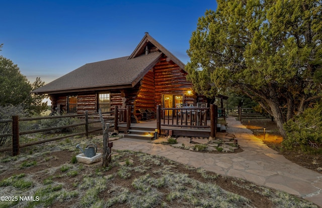 38 Cosnino Rd, Flagstaff, AZ 86004 - view of front of property with log siding, a wooden deck, and roof with shingles