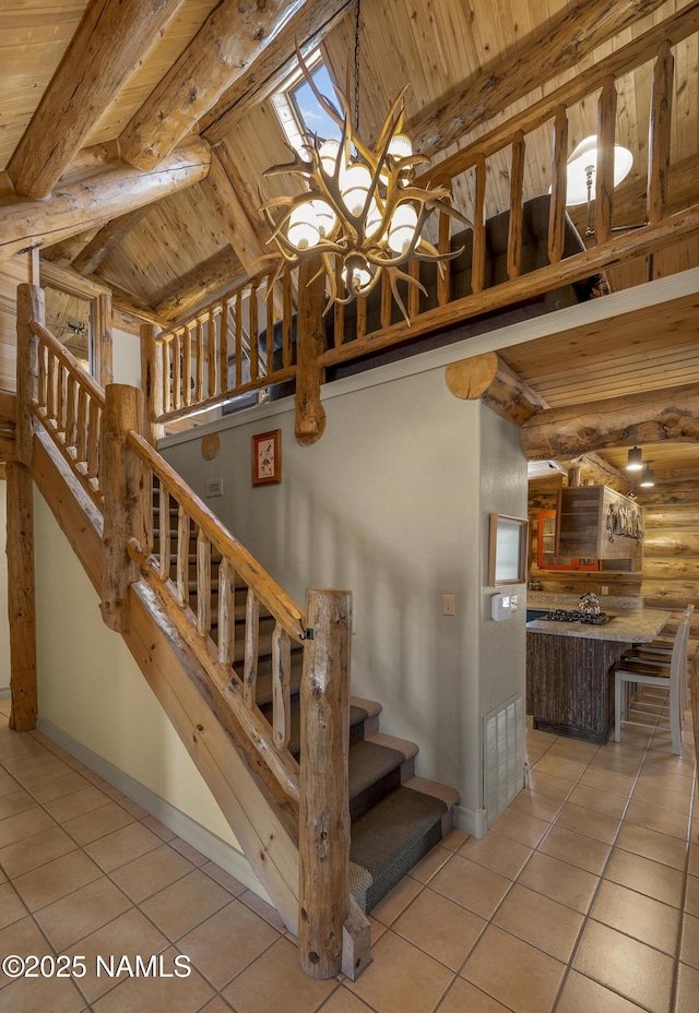 38 Cosnino Rd, Flagstaff, AZ 86004 - stairs with tile patterned floors, wood ceiling with exposed beams, rustic walls, baseboards, and a chandelier