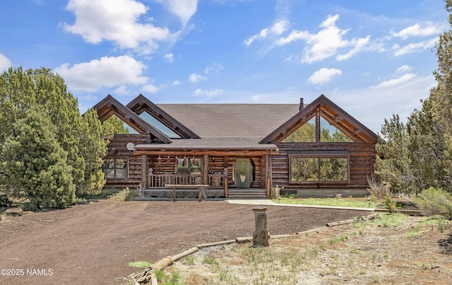 38 Cosnino Rd, Flagstaff, AZ 86004 - log home with log exterior, roof with shingles, and covered porch
