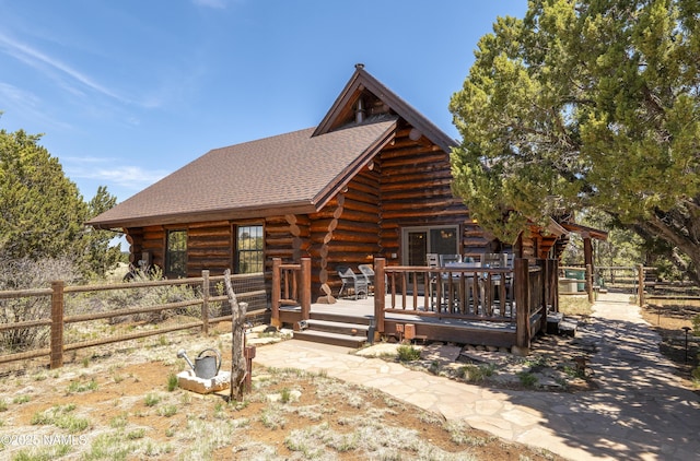 38 Cosnino Rd, Flagstaff, AZ 86004 - log cabin with log siding, a deck, and roof with shingles