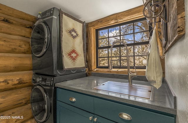 38 Cosnino Rd, Flagstaff, AZ 86004 - laundry room featuring estacked washer and dryer, cabinet space, and wood finished floors