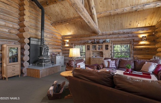 38 Cosnino Rd, Flagstaff, AZ 86004 - living room with a wood stove, wooden ceiling with exposed beams, rustic walls, high vaulted ceiling, and carpet floors