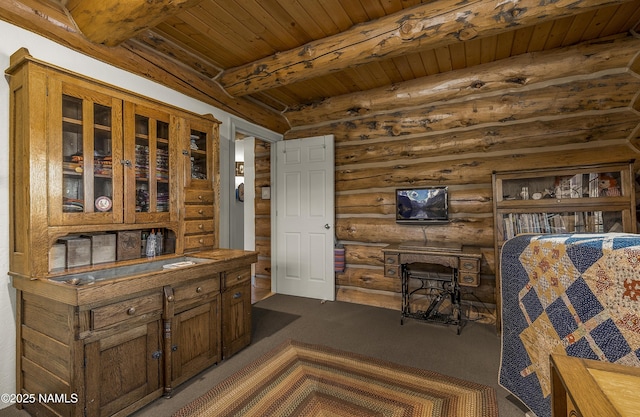 38 Cosnino Rd, Flagstaff, AZ 86004 - bar area featuring log walls, dark colored carpet, and wooden ceiling with exposed beams