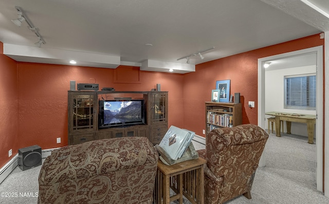 38 Cosnino Rd, Flagstaff, AZ 86004 - carpeted home theater room with track lighting, a textured wall, and a baseboard radiator