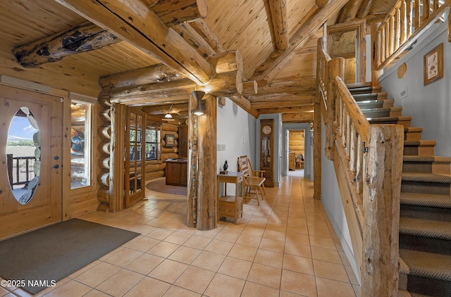38 Cosnino Rd, Flagstaff, AZ 86004 - foyer with light tile patterned flooring, wood ceiling with exposed beams, rustic walls, healthy amount of natural light, and stairway