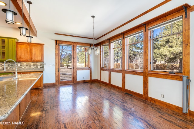 unfurnished sunroom with a sink