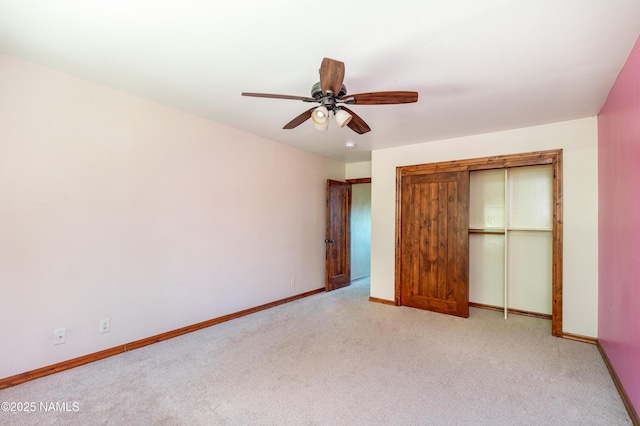 unfurnished bedroom featuring baseboards, light carpet, a closet, and ceiling fan