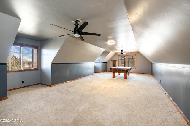 additional living space featuring lofted ceiling, carpet flooring, baseboards, and ceiling fan