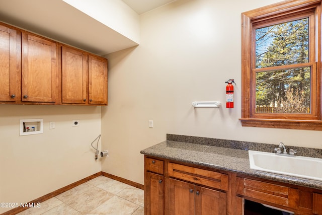 laundry room with baseboards, hookup for an electric dryer, cabinet space, a sink, and washer hookup