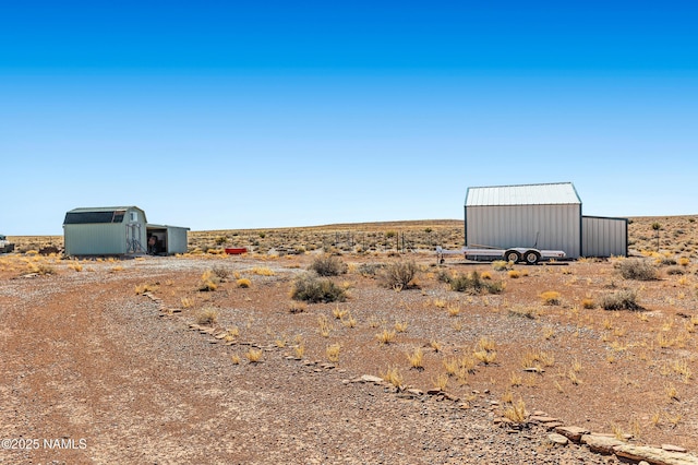 view of yard with a storage shed and an outbuilding