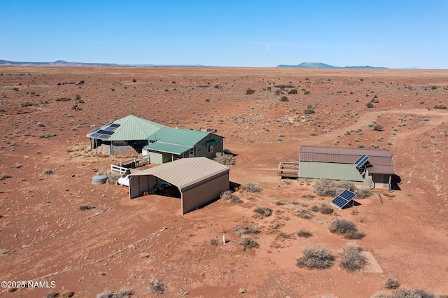 drone / aerial view featuring view of desert and a mountain view