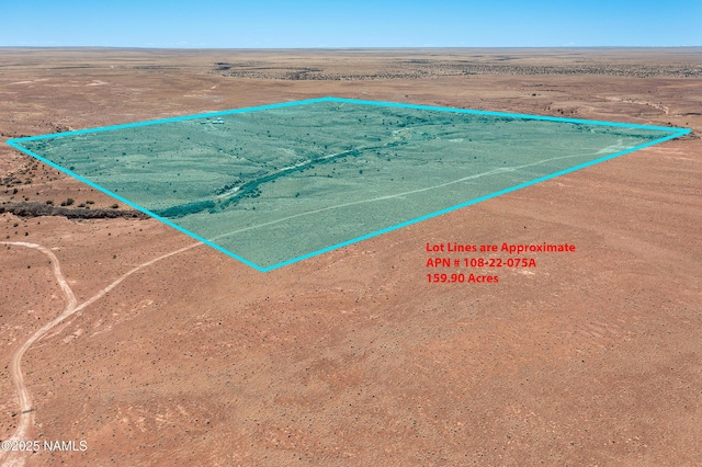 drone / aerial view featuring a desert view and a rural view