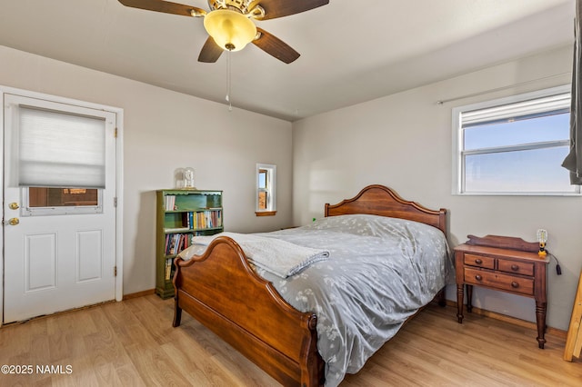 bedroom with light wood-style floors, ceiling fan, and baseboards