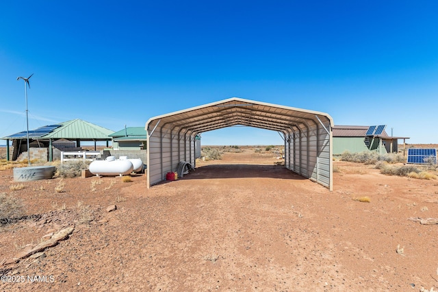 view of outbuilding featuring dirt driveway and a detached carport