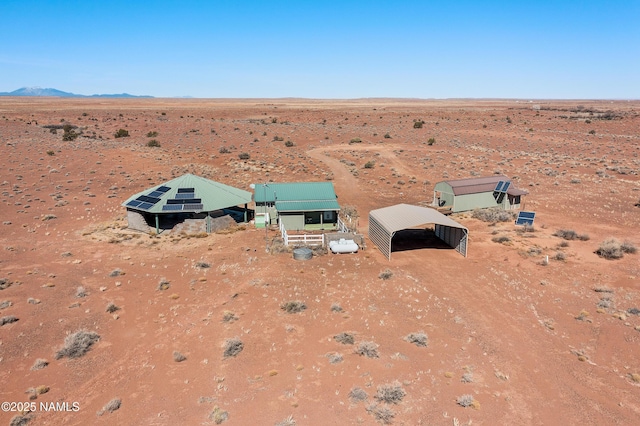 birds eye view of property featuring view of desert and a mountain view