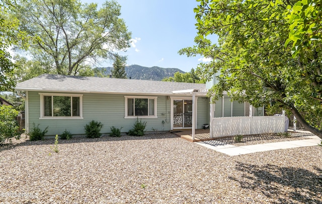 6320 N Mountaineer Rd, Flagstaff, AZ 86004 - single story home featuring a mountain view, a patio area, and roof with shingles