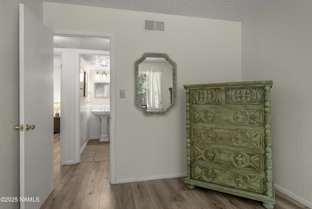 6320 N Mountaineer Rd, Flagstaff, AZ 86004 - corridor with wood finished floors and a textured ceiling