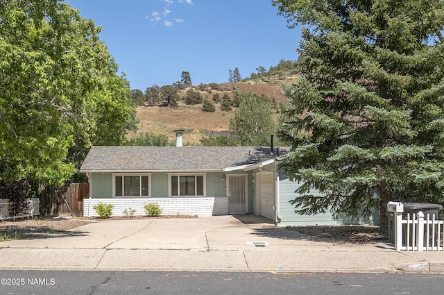 6320 N Mountaineer Rd, Flagstaff, AZ 86004 - view of front of home featuring driveway and roof with shingles